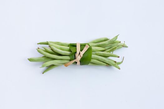 Green beans on white background.