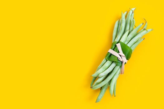 Green beans on yellow background.