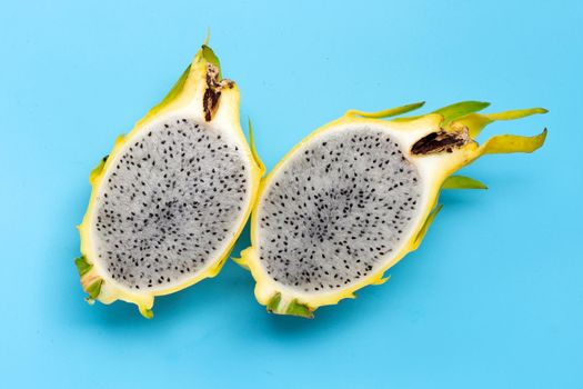 Yellow pitahaya or dragon fruit on blue background.