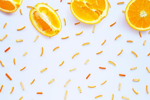 Orange fruit with peels on white background. top view