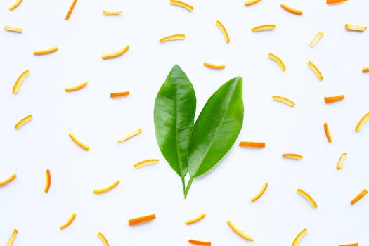 Orange peels leaves on white background. top view