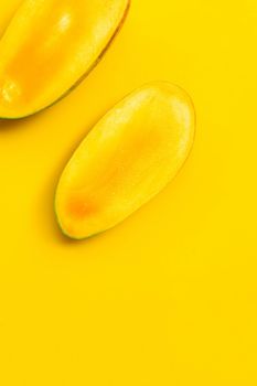 Mango on yellow background. Tropical sweet fruit concept.