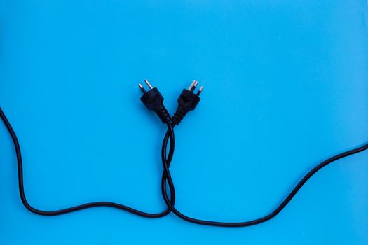 Electric plugs on blue background. Top view