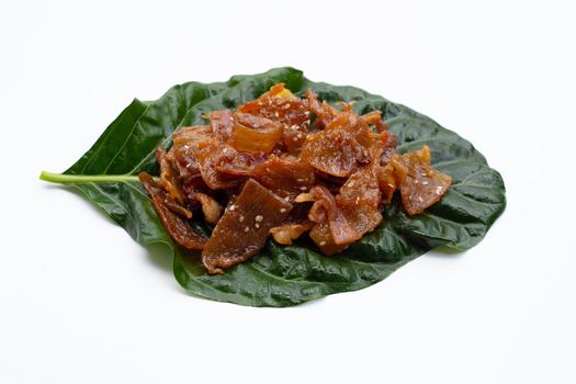 Sweet pork or pork Jerky on noni or morinda citrifolia leaf. white background.