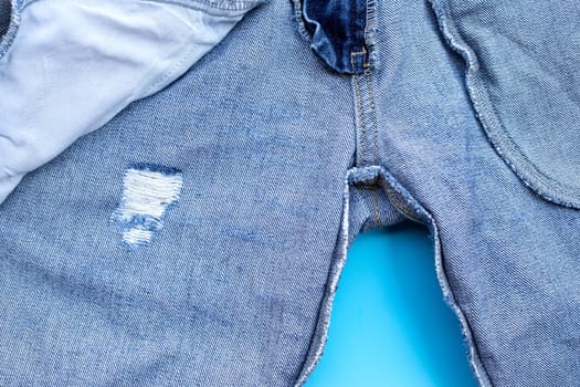 Inside of jeans on blue background. Top view