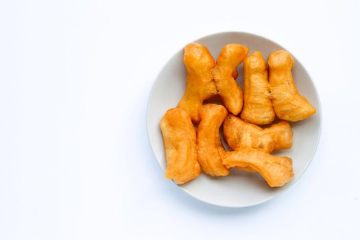 Deep-fried dough stick, chinese bread stick in white dish on white background with copy space