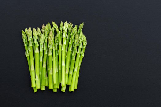 Fresh asparagus on dark background. Copy space