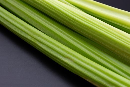Fresh celery on dark background.
