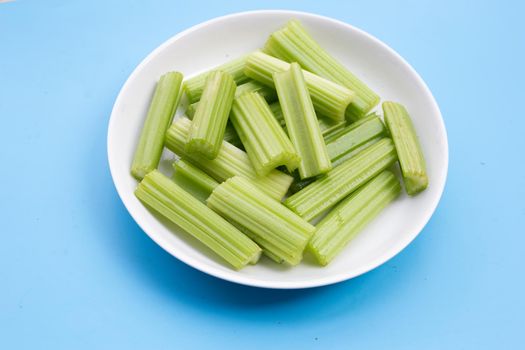 Fresh celery on blue background.