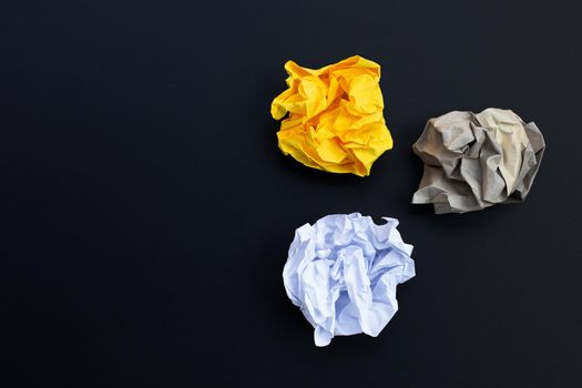 Crumpled paper balls on dark background. Copy space