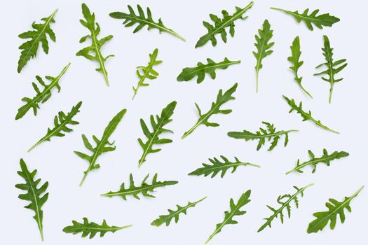 Fresh green rocket salad on white background.