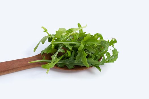 Fresh green rocket salad on white background.