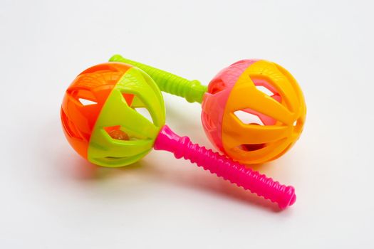 Colorful baby rattles on white background.