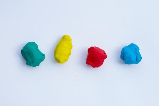Colorful plasticine clay on white background.