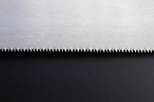 Blade of saw on dark background. Copy space