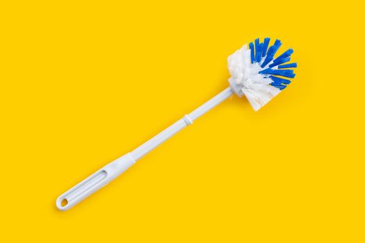 Toilet brush on yellow background. Copy space