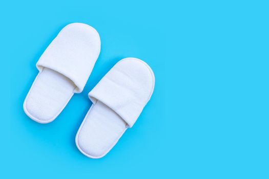 Hotel Slippers on blue background. Copy space