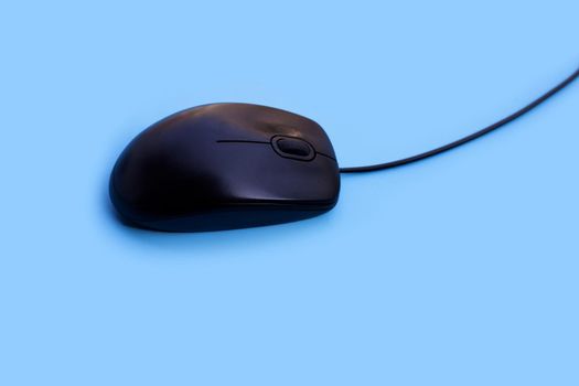 Computer mouse on blue background. Copy space