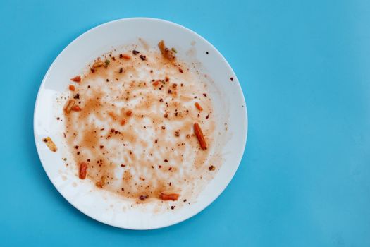 Dirty dish on blue background. Top view