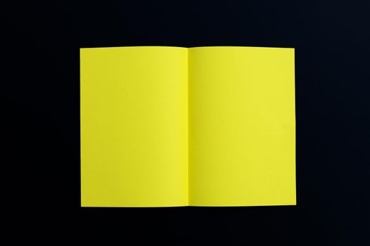 Yellow paper on dark background. Top view