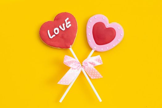 Valentineheart shapped cookies on yellow background.  Copy space