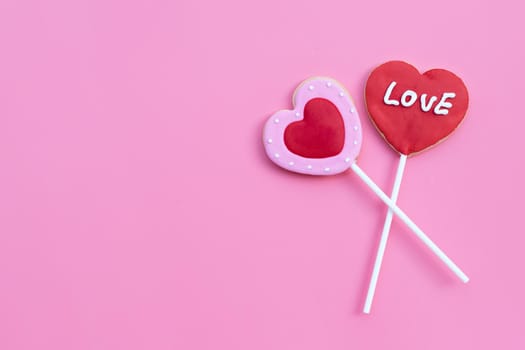 Valentineheart shapped cookies on pink background.  Copy space
