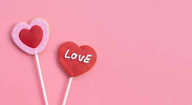  Valentineheart shapped cookies on pink background.  Copy space