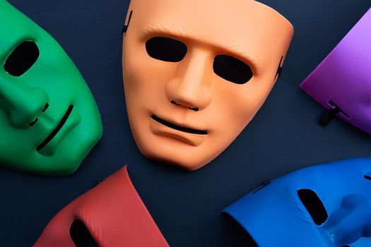 Five face masks on dark background. Top view
