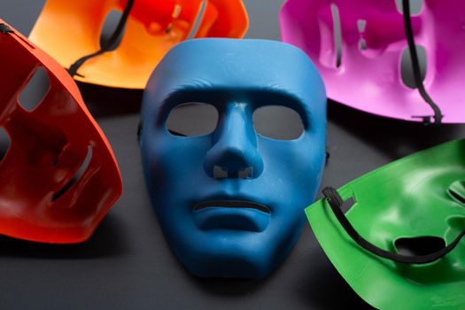 Five face masks on dark background.
