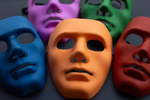 Five face masks on dark background.