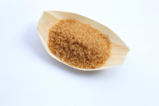 Brown sugar on white background. Copy space