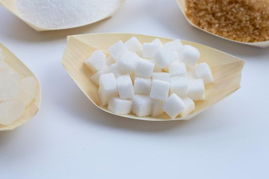 Various types of sugar on white background.