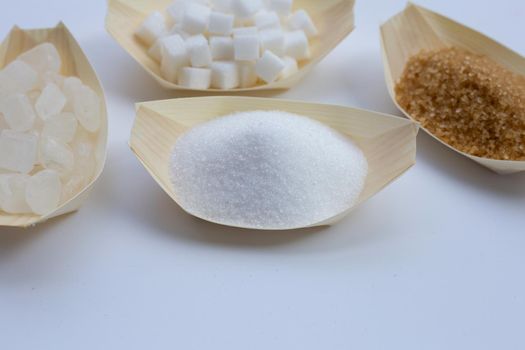 Various types of sugar on white background.