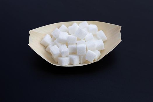 Cubes of sugar on dark background. Copy space