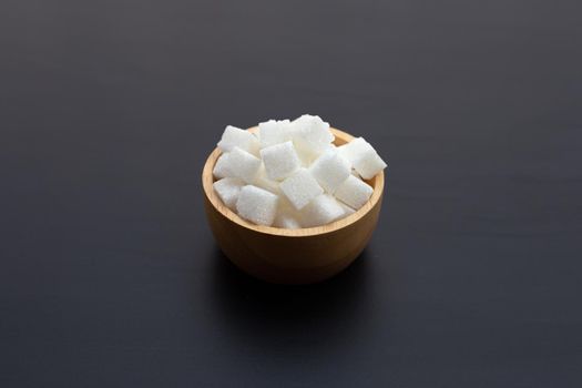 Cubes of sugar on dark background. Copy space