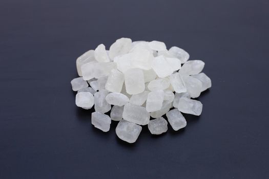 Crystal rock sugar on dark background. 