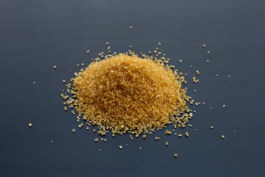 Brown sugar on dark background. 
