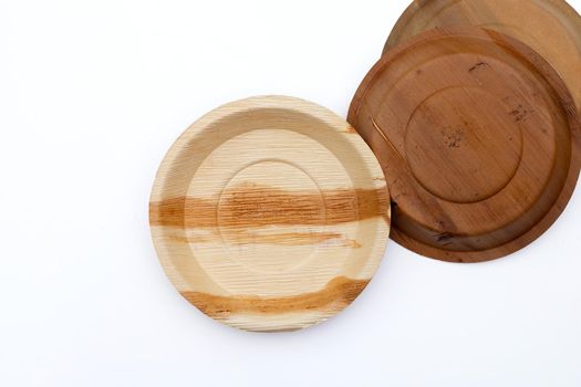 Betel palm leaf plates on white background.