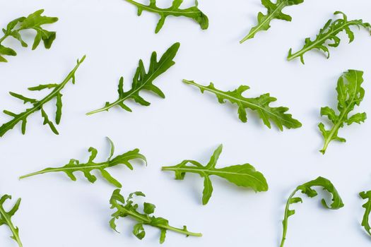 Fresh green rocket salad on white background.