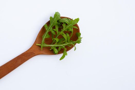 Fresh green rocket salad on white background.