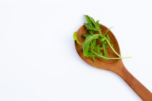 Fresh green rocket salad on white background.
