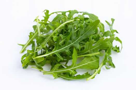 Fresh green rocket salad on white background.