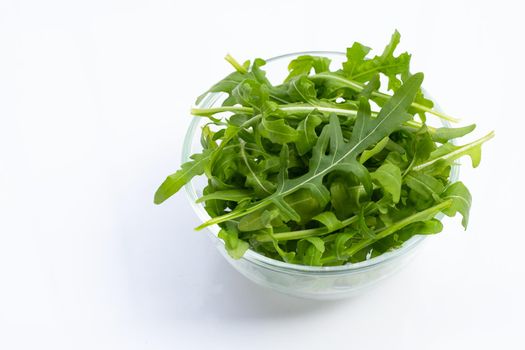 Fresh green rocket salad on white background.