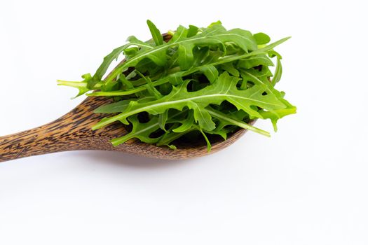 Fresh green rocket salad on white background.