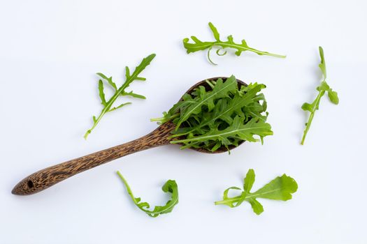 Fresh green rocket salad on white background.