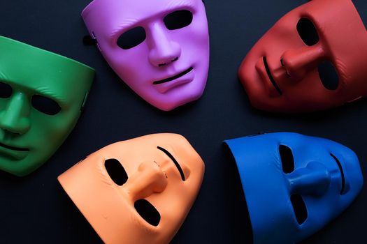 Five face masks on dark background. Top view