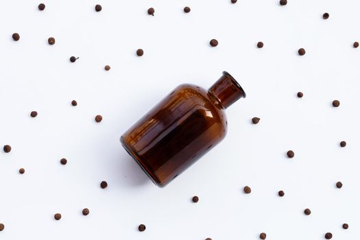 Medicine Bottle with allspice isolated on white background