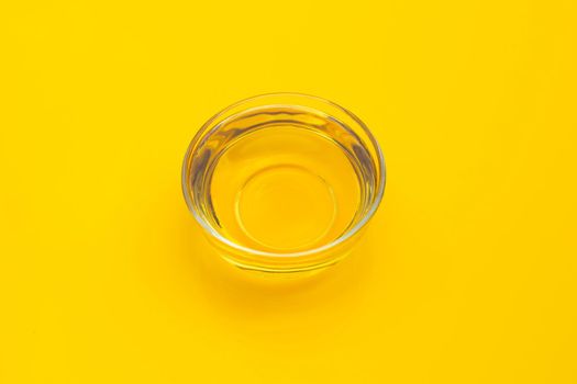 Rice bran oil on yellow background.