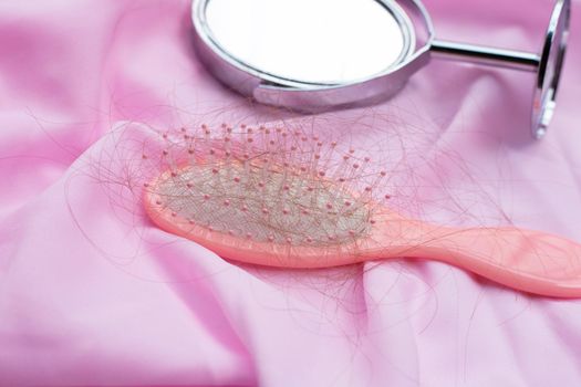 Hairs loss fall in comb on  satin fabric 