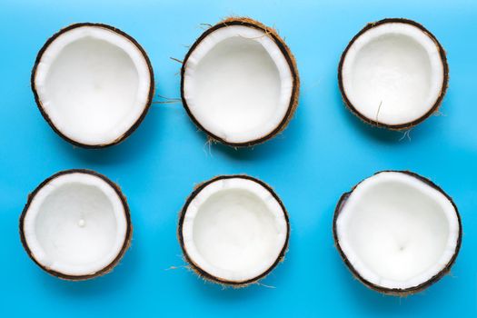 Coconuts on blue background. Top view